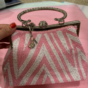 pink and white handbag with charm